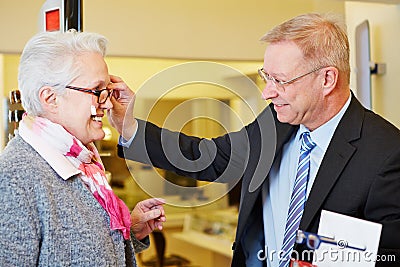 Woman buying glasses at optician