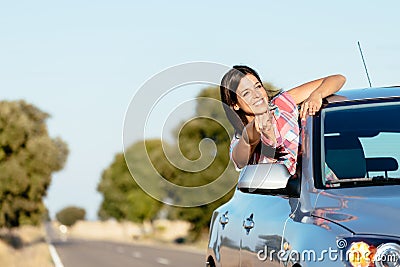 Woman on car roadtrip enjoying freedom