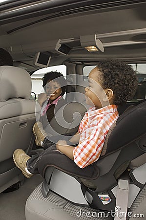 Woman In Car With Small Boy In Foreground