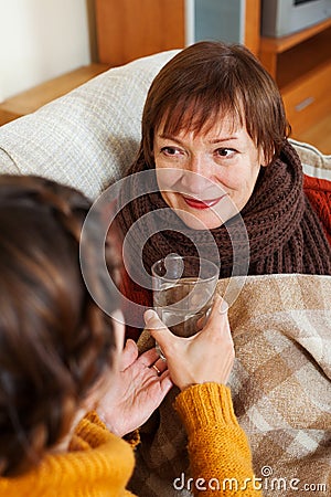 Woman caring for unwell senior mother