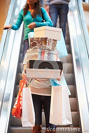 Woman Carrying Boxes And Bags In Shopping Mall