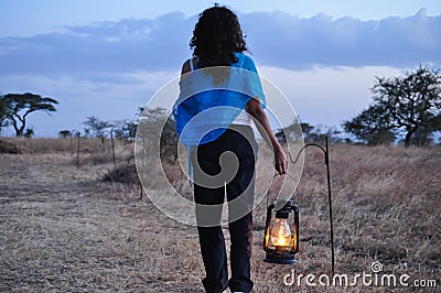 Woman carrying lamp