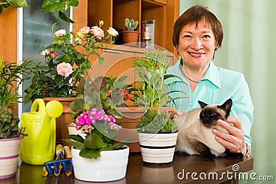 Woman with cat and flower plants