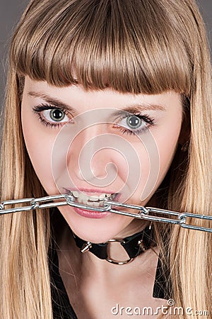 Woman with a chain in teeth