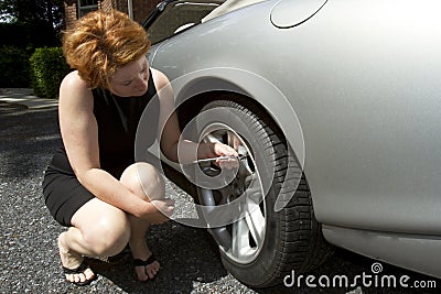 Woman Checking Tire Pressure