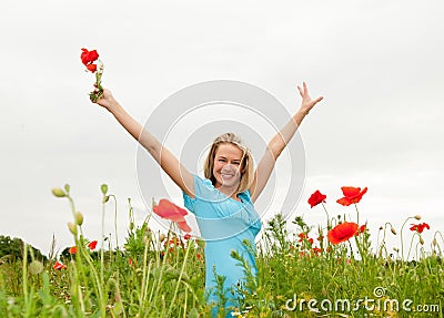 Woman cheering in the poppy field