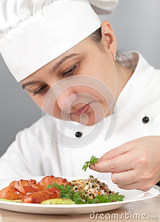 Chef puts vegetables on a plate