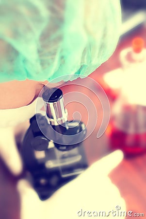 Woman in chemistry lab with microscope