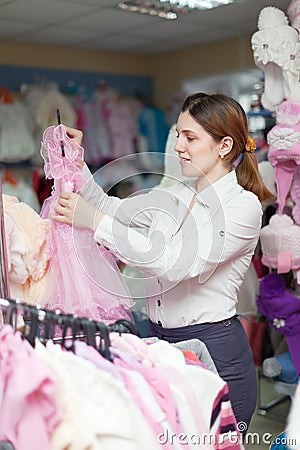 Woman chooses dress for daughter