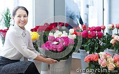 Woman chooses roses at flower store