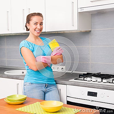 Woman cleans the kitchen