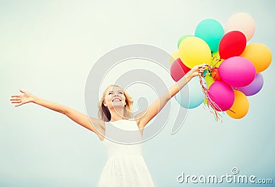 Woman with colorful balloons outside