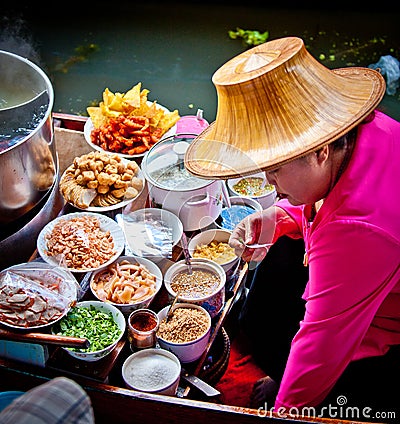 Woman cooking food in bangkok floating market