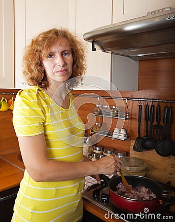 Woman cooks meat