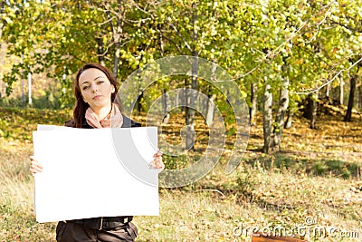 Woman in the countryside holding a card