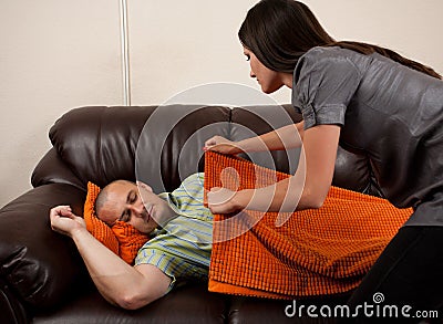 Woman covering her husband with a blanket