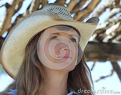 A Woman in a Cowboy Hat Under a Ramada