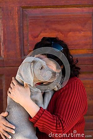 Woman cuddling pet dog