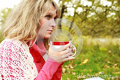Woman with cup of hot tea in outdoor