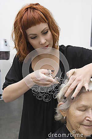 Woman Cutting Female Client s Hair In Salon