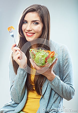 Woman diet concept portrait. Female model hold green salad.