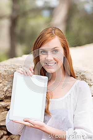 Woman displaying a blank tablet screen