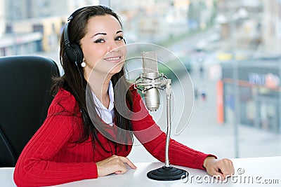 A woman DJ is in front of a mic