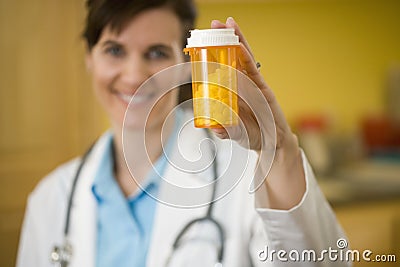 Woman Doctor holding bottle of pills
