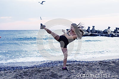 Woman doing martial arts at the beach