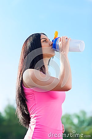 Woman drink water bottle sport on stadium