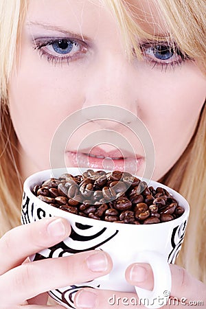 Woman drinking from coffee cup beans