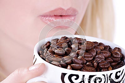 Woman drinking from coffee cup beans