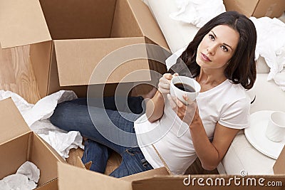 Woman Drinking Coffee Unpacking Boxes Moving House