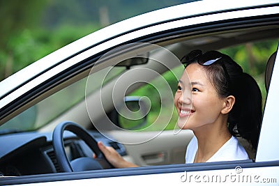 Woman driver driving in the nature