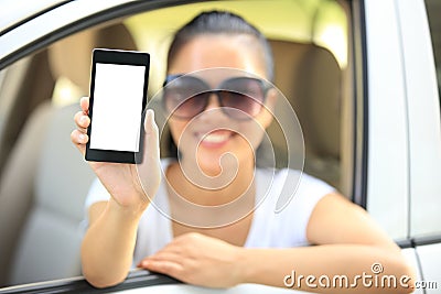 Woman driver hold blank cell phone in car