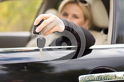 Woman driver holding out her keys