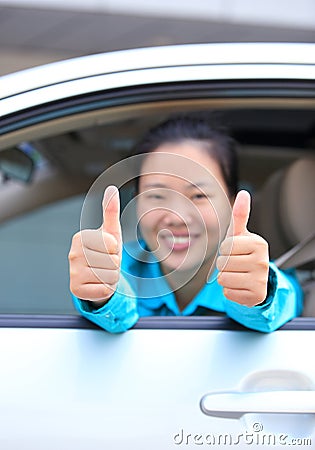 Woman driver thumb up in car