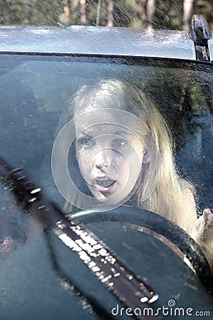 Woman driving a car in the rain