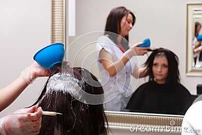 Woman dying hair in hairdressing beauty salon. Hairstyle.