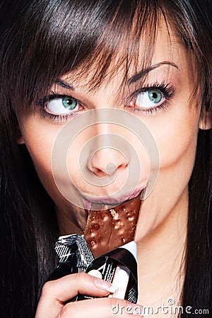 Woman eat chocolate bar