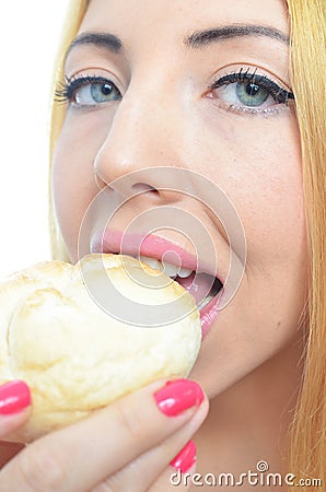 Woman eating bread roll