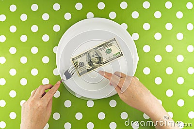 Woman eating hundred dollar bill for dinner