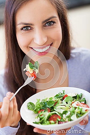 Woman eating salad