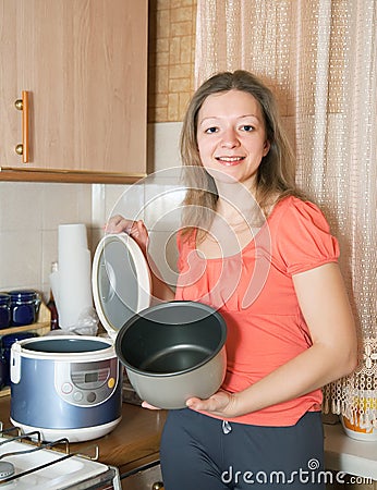 Woman with electric slow cooker