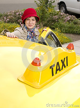 Woman enters a Yellow Taxi Downtown
