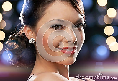 Woman in evening dress wearing diamond earrings