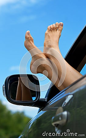 Woman feet out of car window