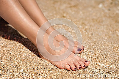 Woman feet on sand