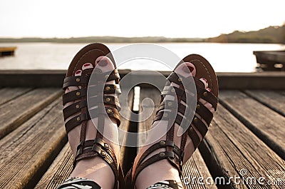 Woman feet in sandals and red nails