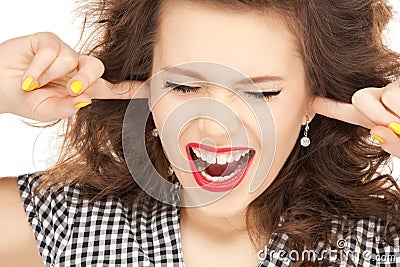 Woman with fingers in ears